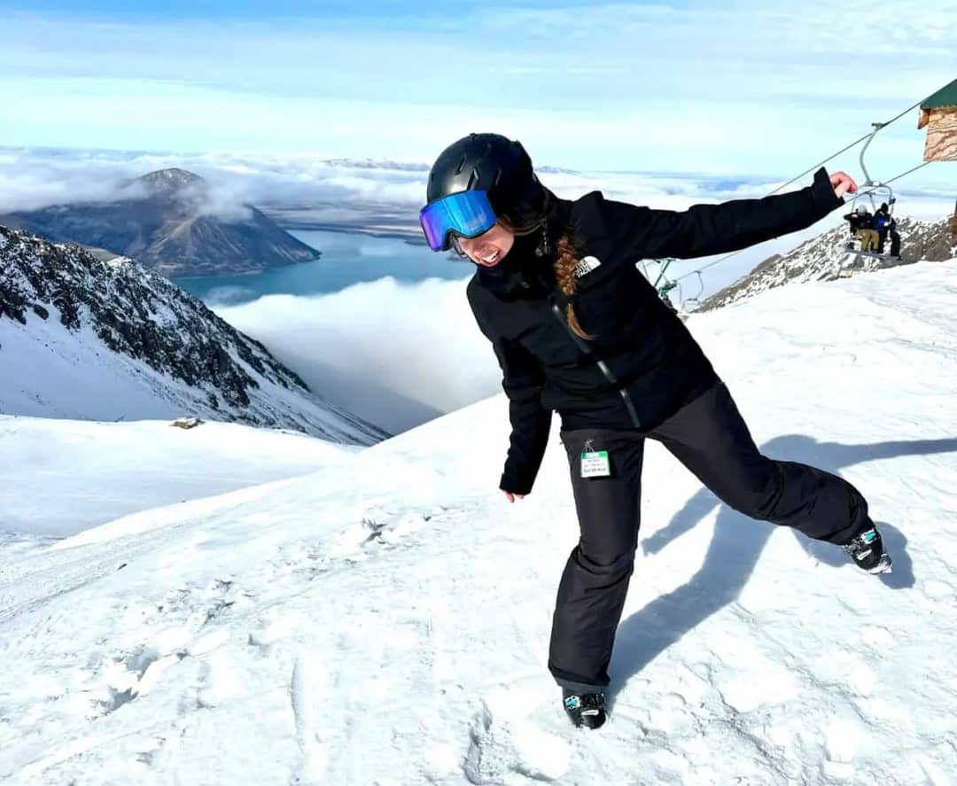 Olivia Lufman, adventure guide and marketing at Swiss Local Adventures, skiing in the mountains