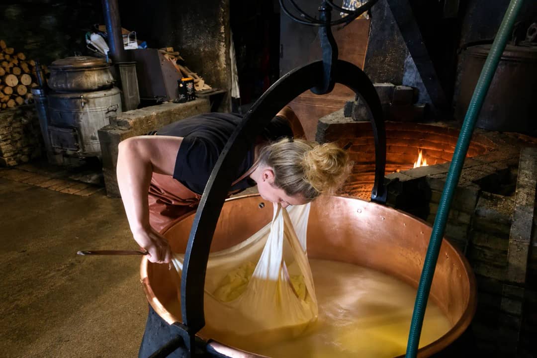 Daniela making alpine cheese in copper vat at her Justistal farm