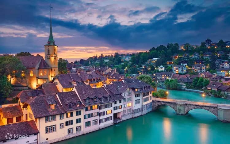 Bern old town at dusk with Aare River, medieval stone bridge and church spire, UNESCO World Heritage Switzerland