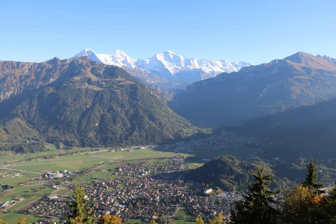 Interlaken im Talboden unter den verschneiten Gipfeln der Jungfrauregion, von weit oben aus betrachtet
