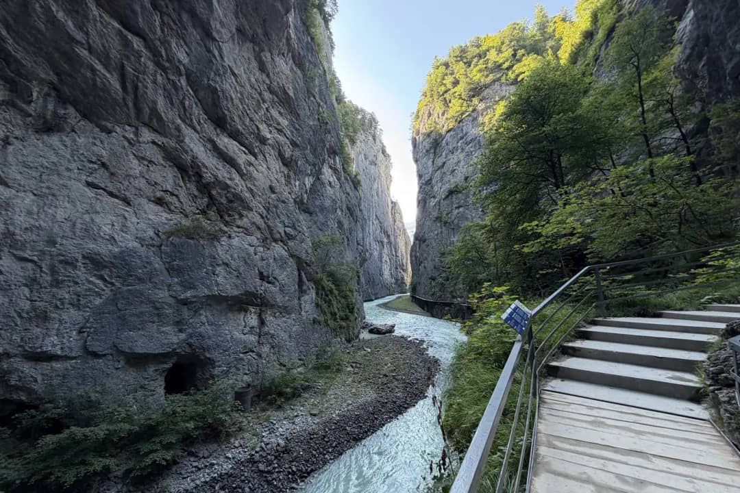 Turquoise Aare river between limestone cliffs beside the wooden walkway of the Aare Gorge near Meiringen