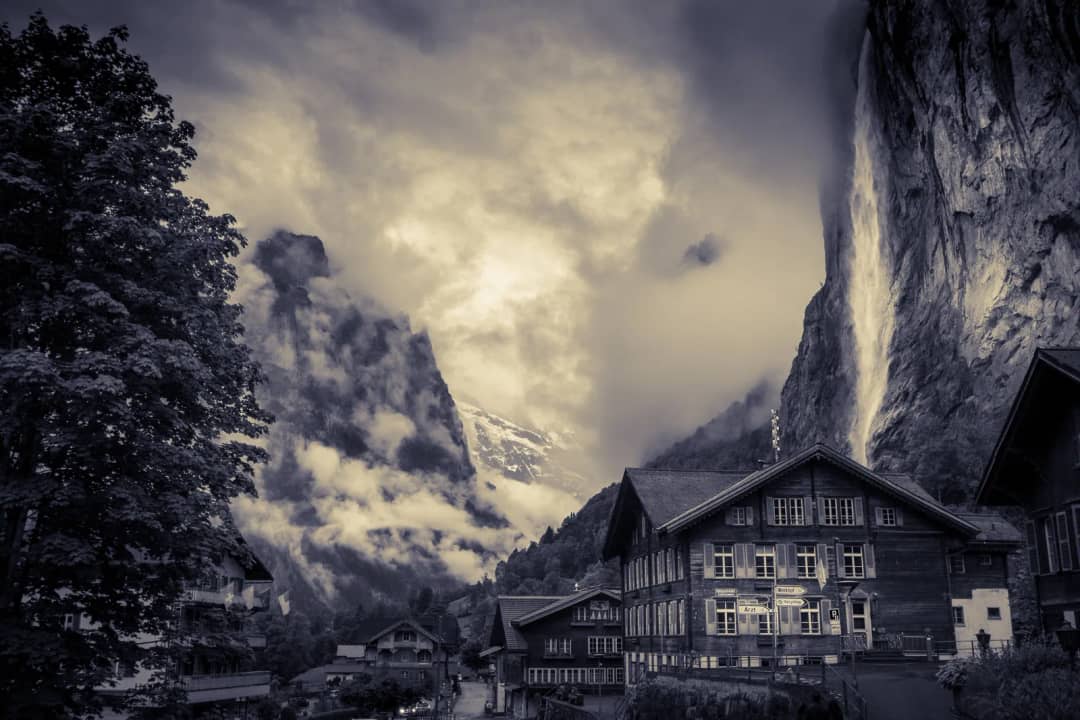 Chalets below the Staubbach falls in Lauterbrunnen, the free morning viewpoint before the coaches arrive