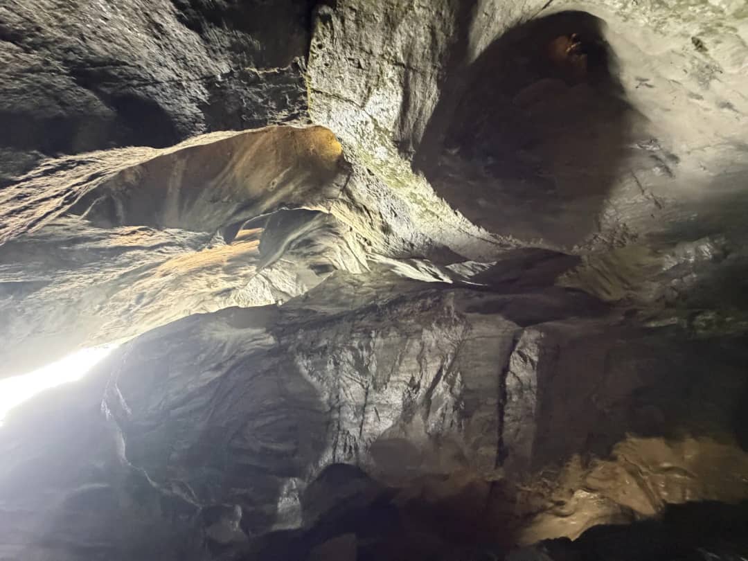 Inside the Trümmelbach Falls near Lauterbrunnen, wet rock lit in the tunnel where queues build in August