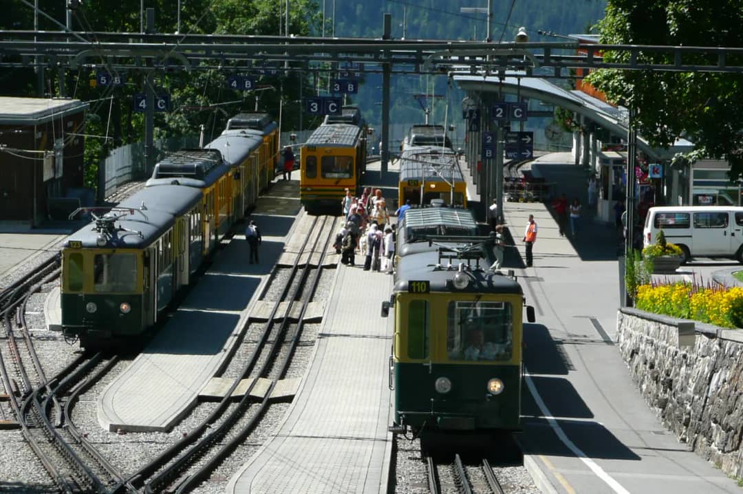 Green and yellow rack railway trains at Wengen station, on the line from Lauterbrunnen to Kleine Scheidegg
